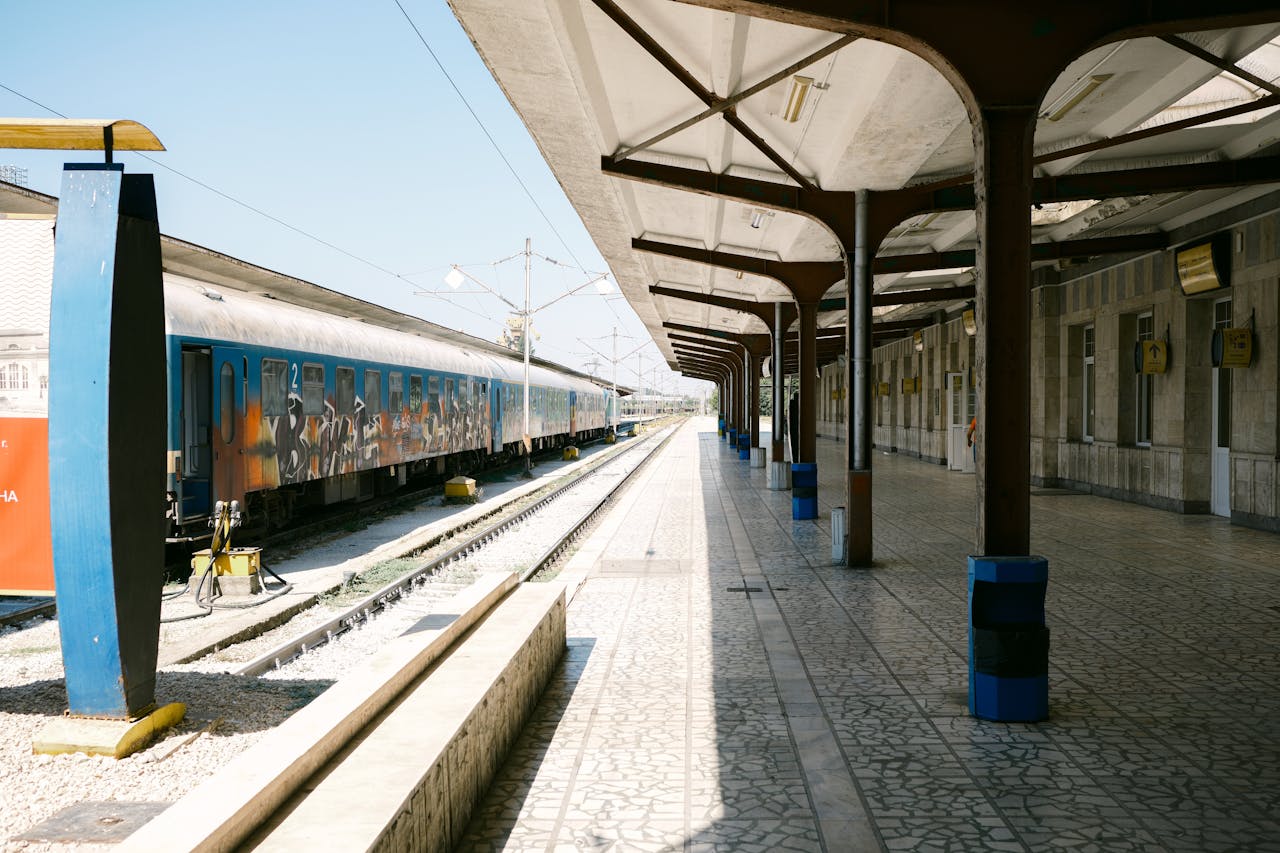 A serene train station platform in Varna, Bulgaria, captured in bright daylight.